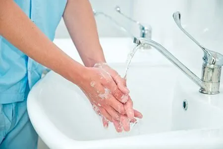 staff person washing their hands
