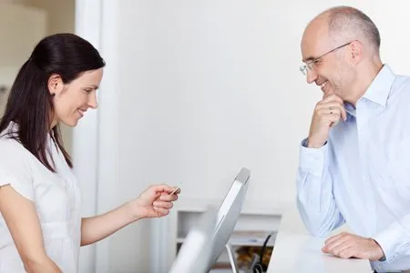 staff discussing insurance info with patient